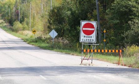 Road with closure sign posted