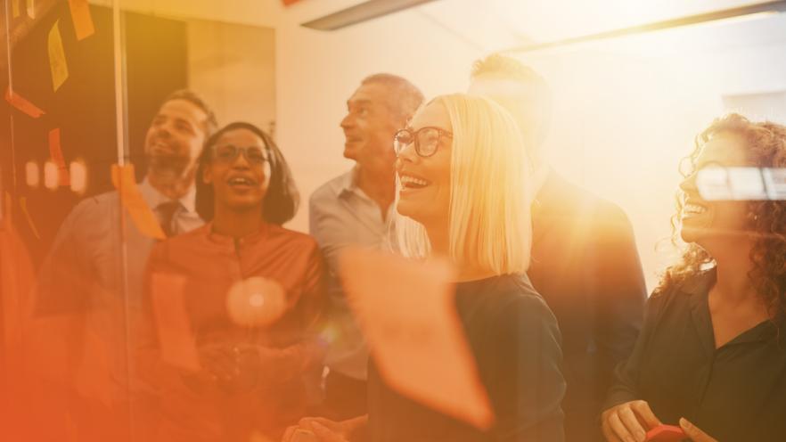 Group sticking post-it notes on wall