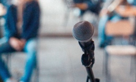 Microphone with public meeting in background