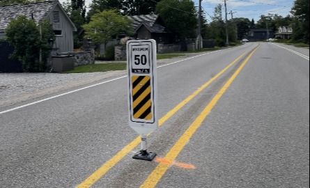 Speed sign stating 50 km an hour on road