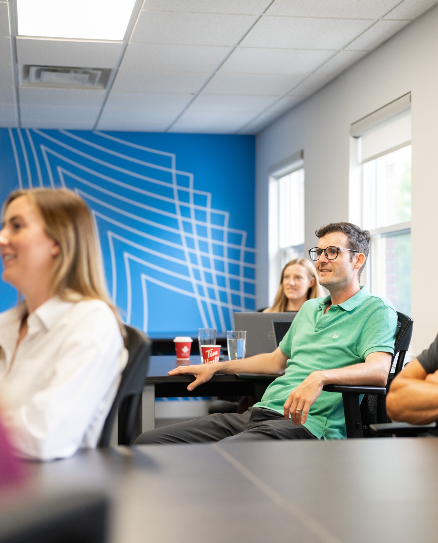 People listening to speaker in meeting