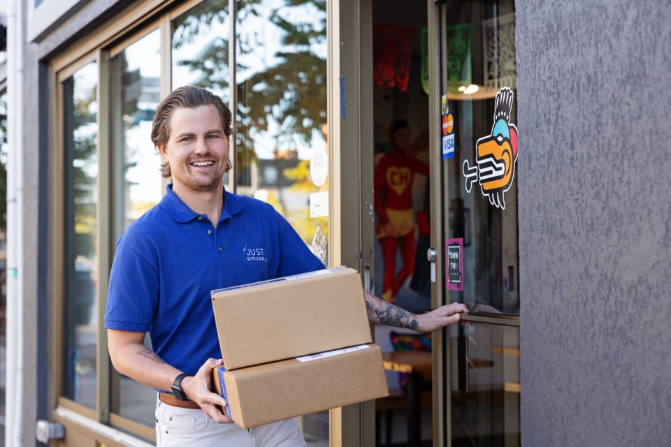 Andrew de Jong, founder and chief executive officer of Just Simcoe holding boxes of product to be shipped to his customers.