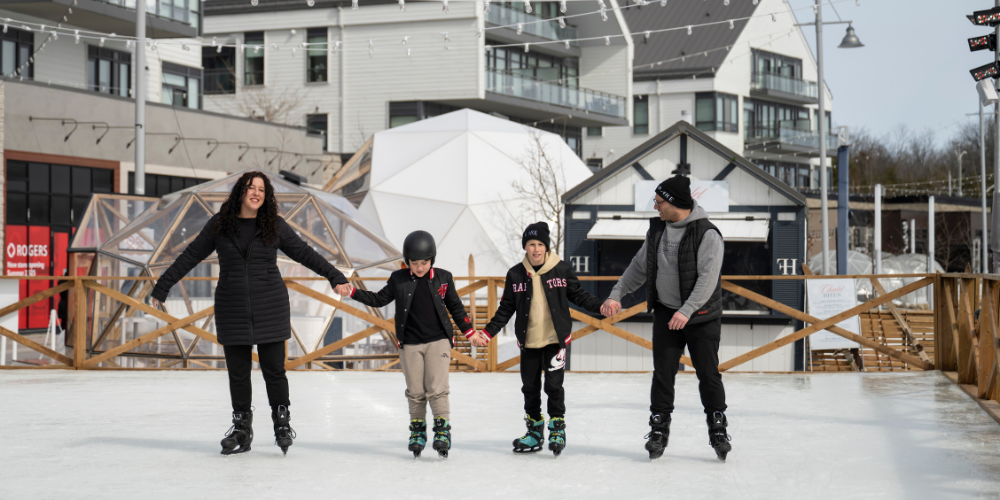 Family skating on the outdoor ice rink at Friday Harbour Resort in Innisfil