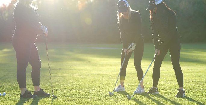 Three woman golfing