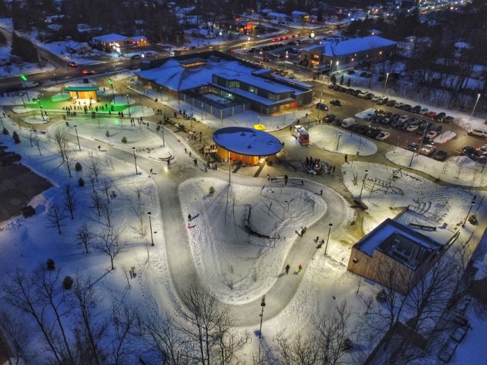 Aerial of ice skating trail and event performances at town square