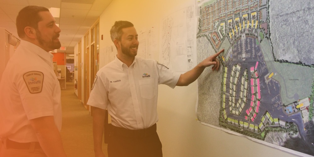 by-law staff reviewing map on the wall