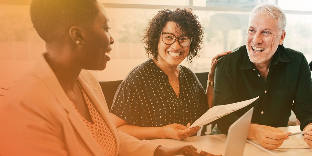 Group of three employees smiling