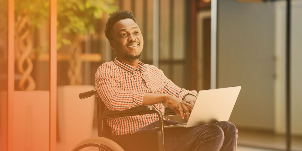 man in wheel chair smiling