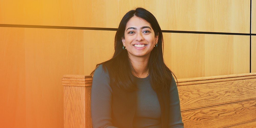 employee smiling on bench