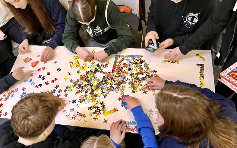 Teens working on a puzzle