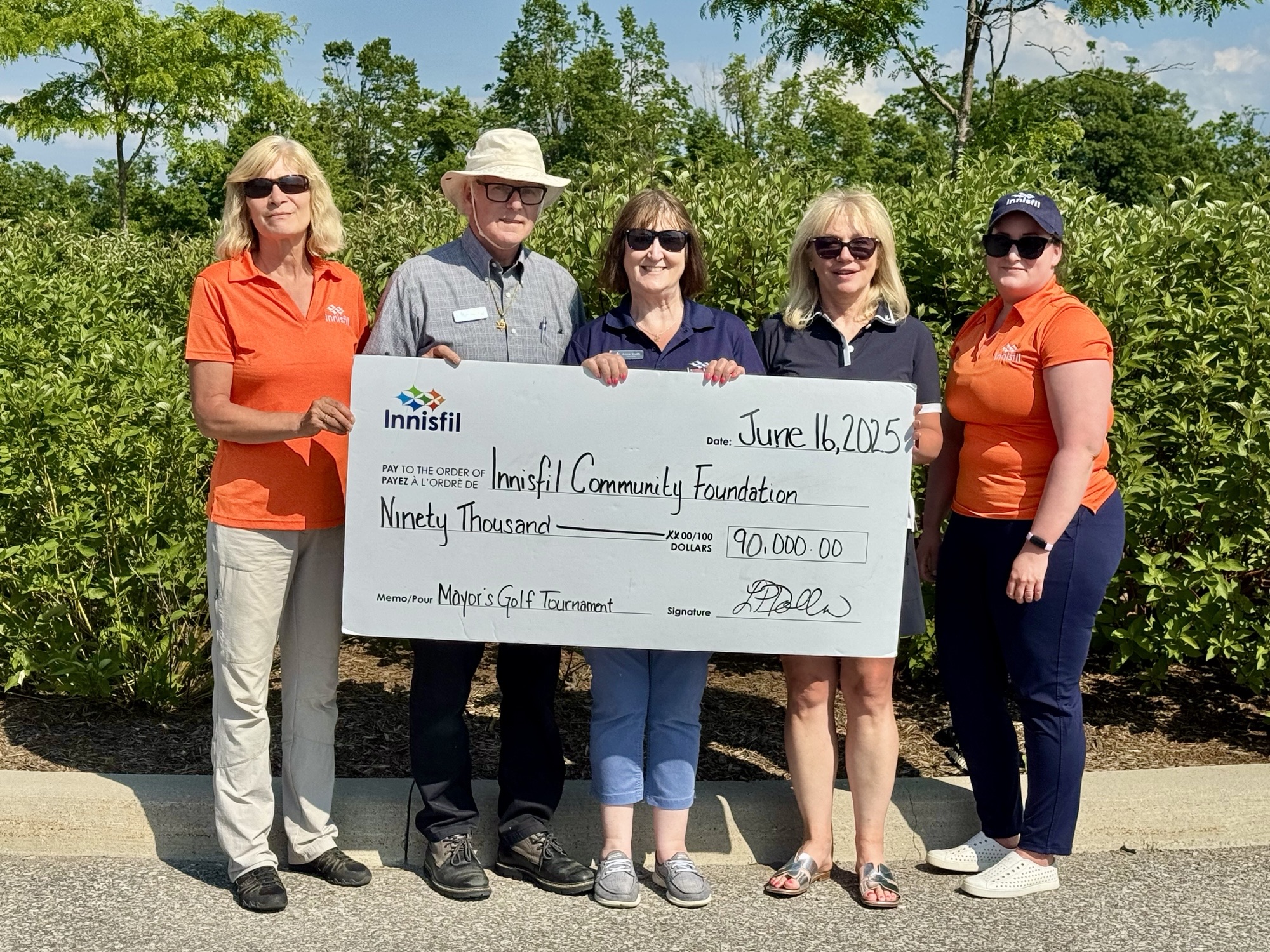 ICF members holding cheque with $90,000
