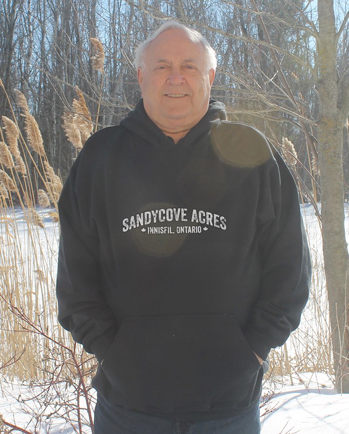Older man wearing black hoodie that says Sandycove
