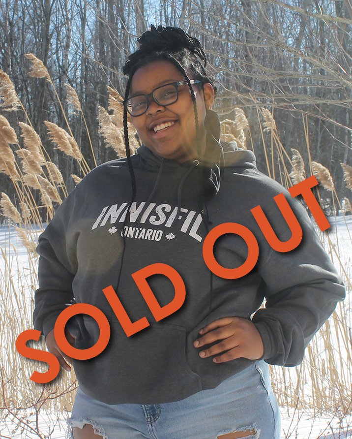 Girl wearing hoodie that says Innisfil - sold out
