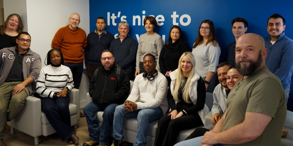 Entrepreneurs sitting at DMZ smiling for photo