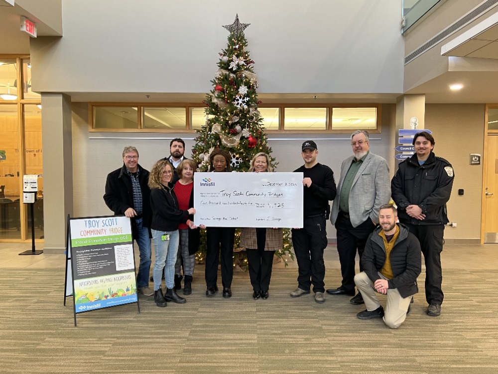 Innisfil Council with Town staff holding cheque