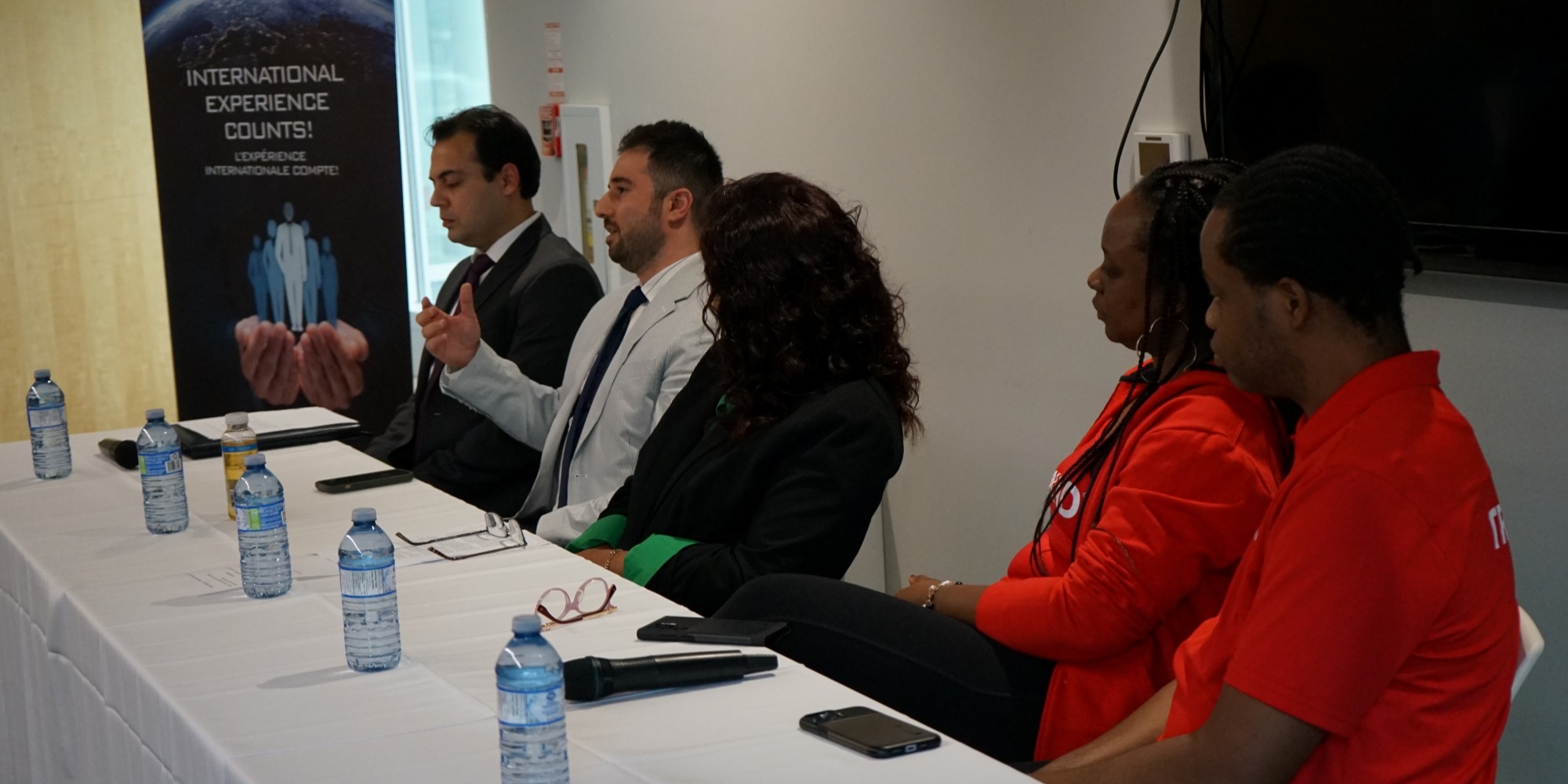 Panel of people speaking during presentation