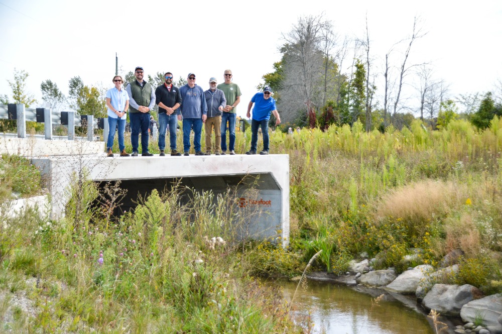 Tour group standing on top of culvert
