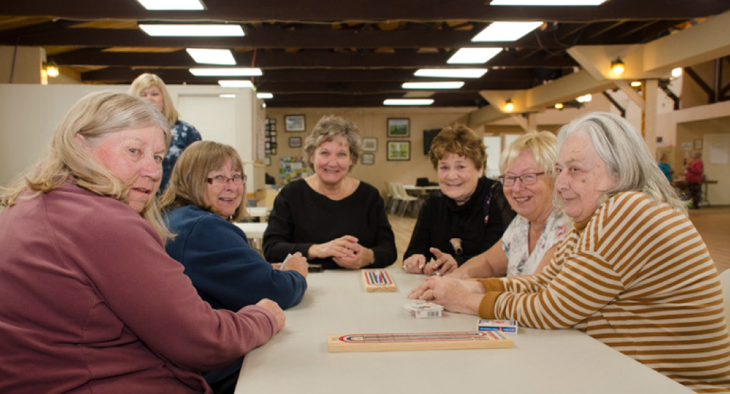 Seniors playing a card game together