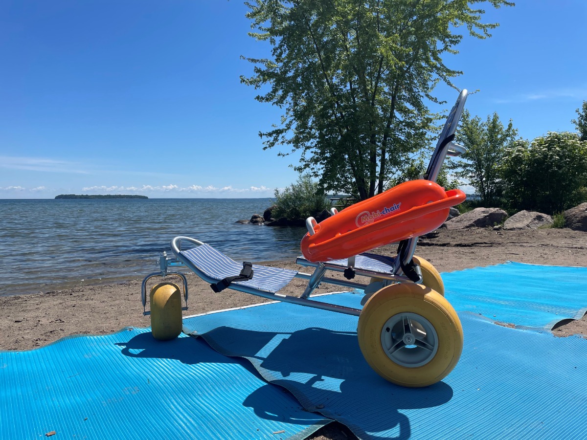 Beach wheelchair on beach facing water