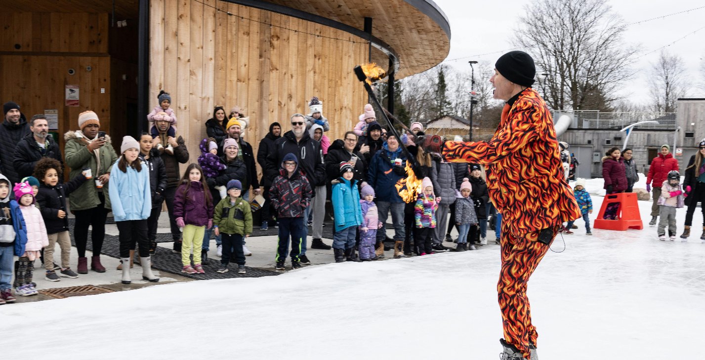 Fire performer skating on ice trail 