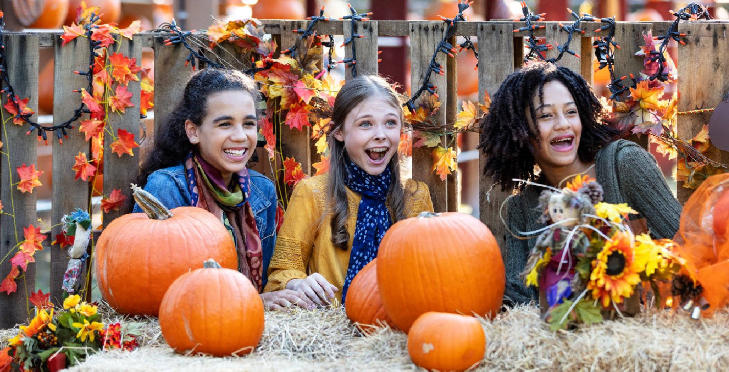 Teens smiling at pumpkin patch