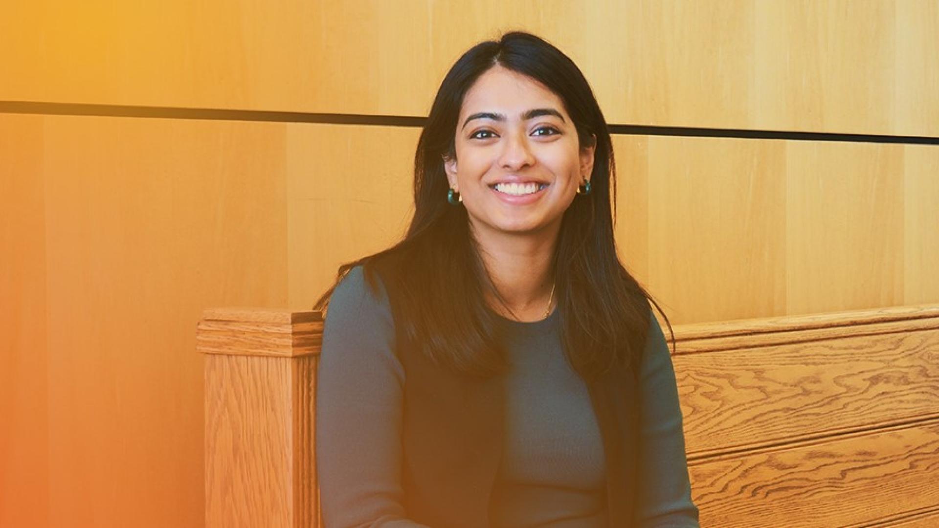 employee smiling on bench