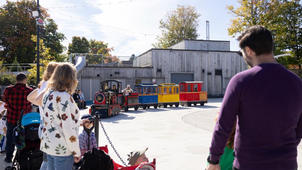 Children waiting in line as trackless train pulls up for fun rides