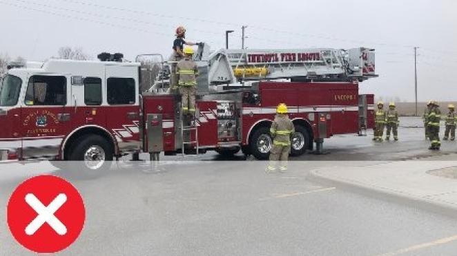 Innisfil fire truck with firefighters standing around it