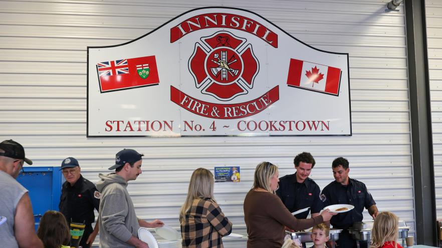 Families lining up for pancake at station 4 breakfast