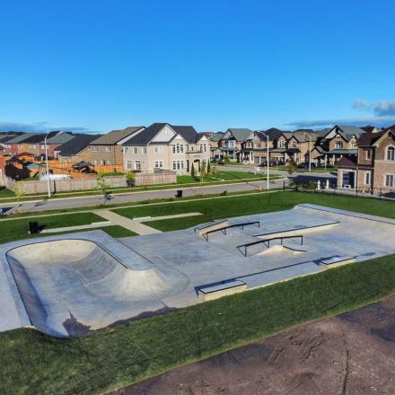 Arial view of a skatepark with handrails, ledges, bowl, and other skatepark elements