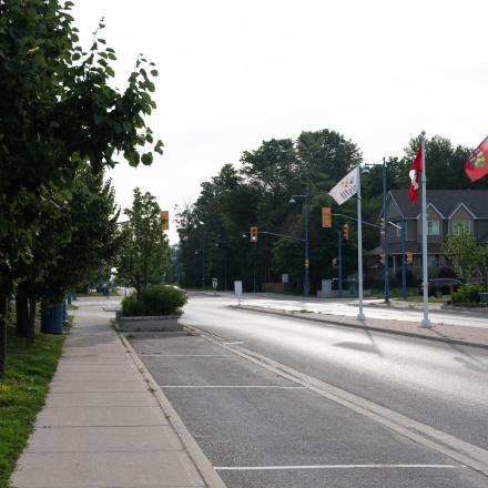 Empty sidewalk beside a street