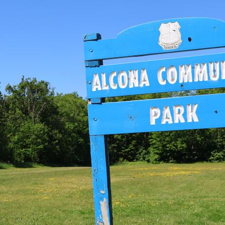Open field with park sign