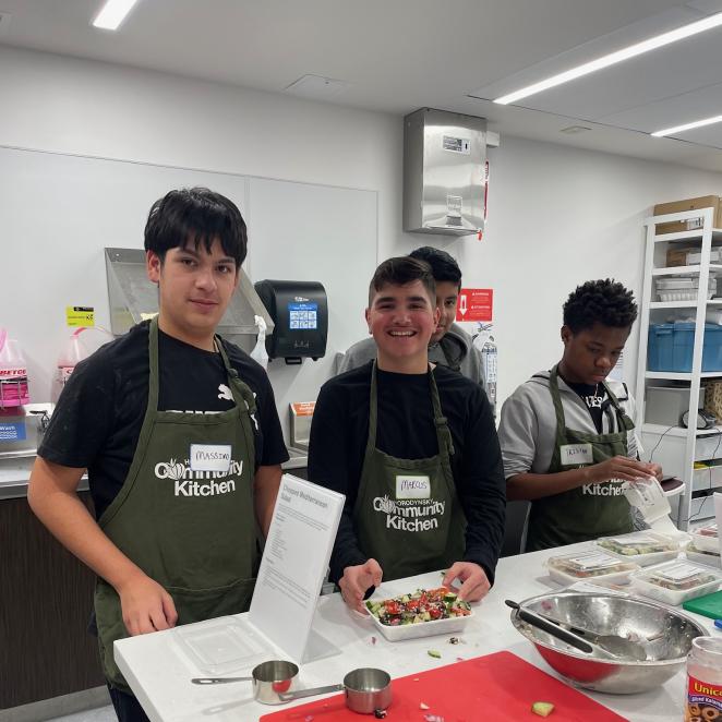 Happy teen boys in cooking class