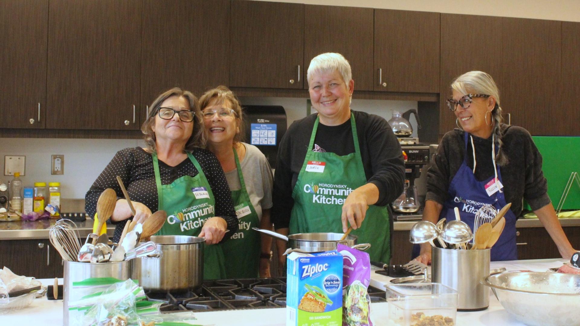 Women cooking meal in community kitchen