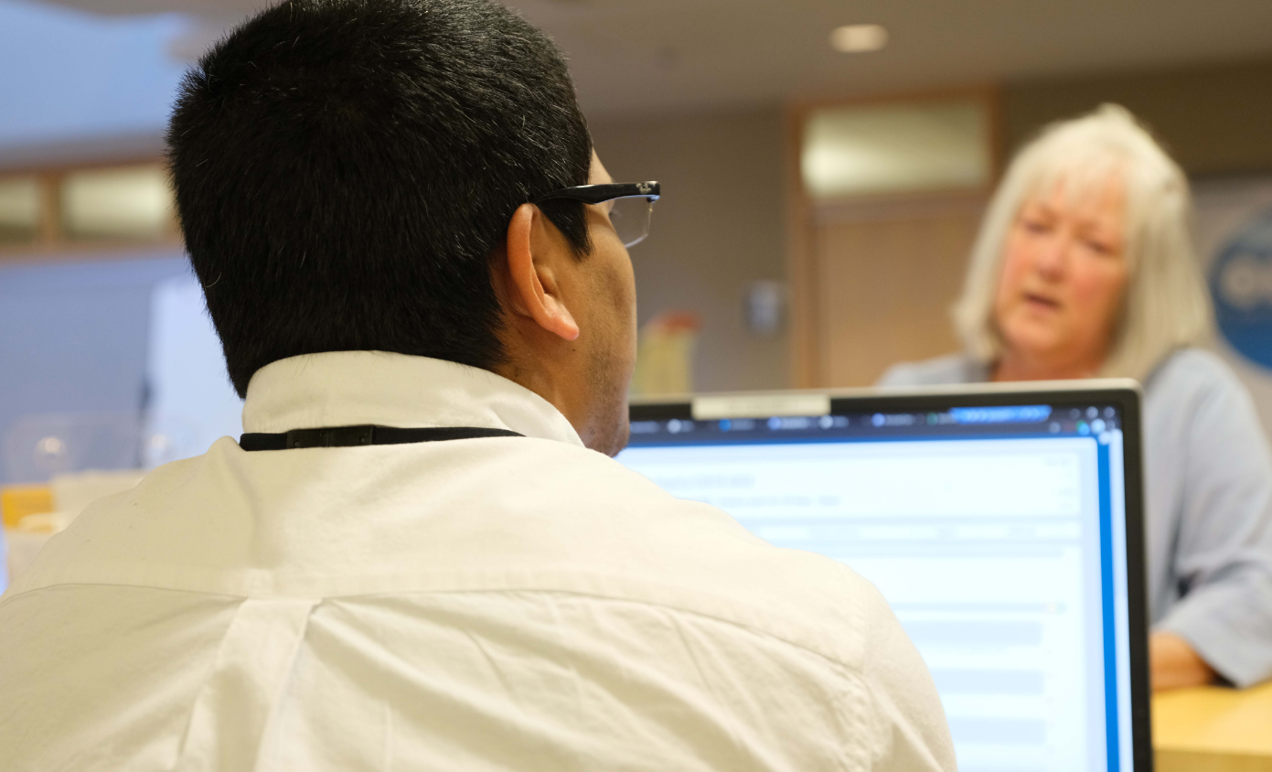 Customer service person talking to customer at front counter